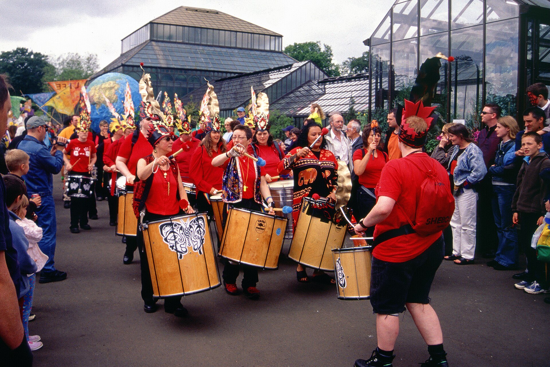 Crowds and drummers celebrating together at a street festival in Glasgow's West End